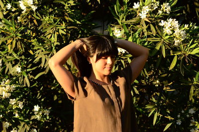 Young woman standing amidst plants