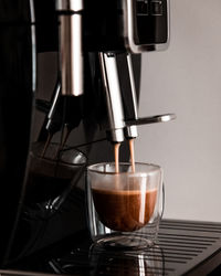 Close-up of coffee cups in glass