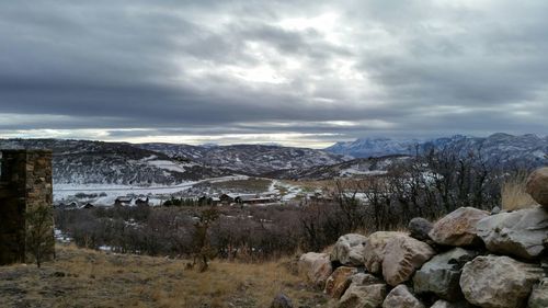 Scenic view of mountains against cloudy sky