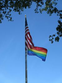 Low angle view of flag against clear blue sky