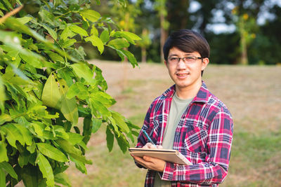 Portrait of young man standing outdoors