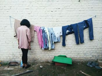 Rear view of clothes drying against wall