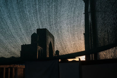 Low angle view of silhouette building against sky