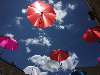 Low angle view of umbrellas against sky