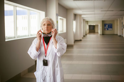 Female doctor standing in hospital lobby