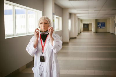 Full length of woman standing in corridor