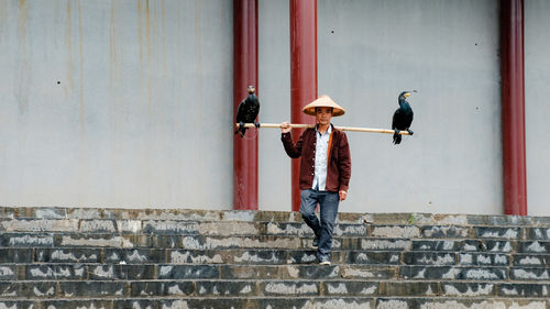 Men standing against wall