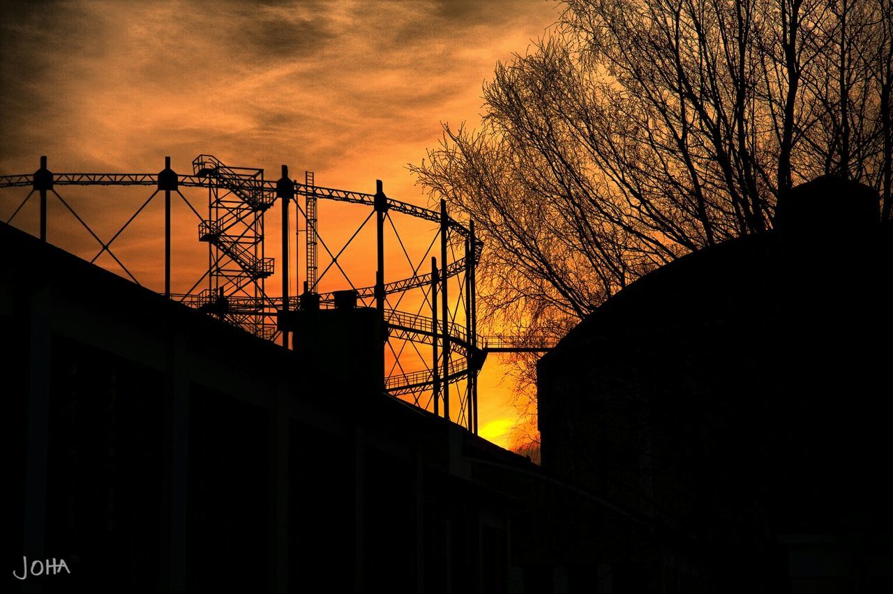 silhouette, sunset, architecture, built structure, building exterior, sky, cloud - sky, bare tree, low angle view, orange color, tree, dusk, building, city, cloudy, dark, outdoors, cloud, connection, nature