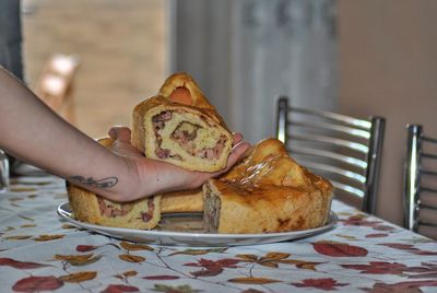 Close-up of hand holding  a savory pie