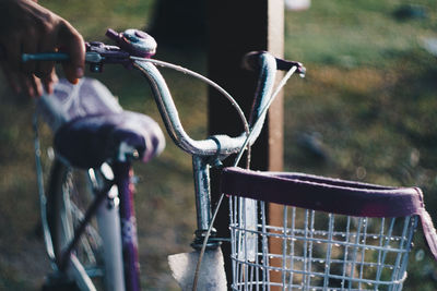 Cropped hand of woman holding bicycle