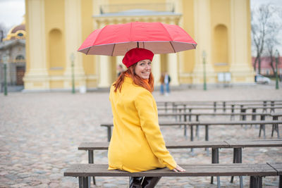 Portrait of woman with umbrella in rain