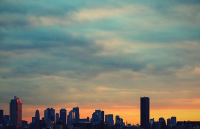 Cityscape against cloudy sky