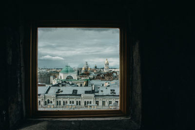 Buildings in city seen through window