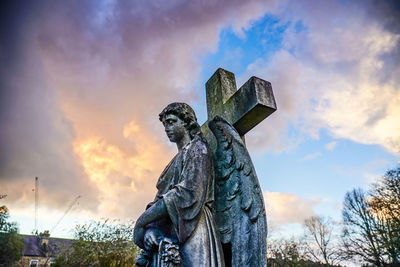 Low angle view of statue against sky during sunset