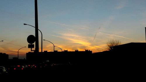 Silhouette trees against sky at dusk