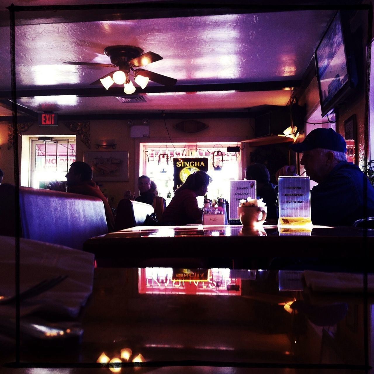 indoors, men, sitting, illuminated, lifestyles, person, restaurant, leisure activity, chair, transfer print, table, medium group of people, auto post production filter, night, rear view, standing, togetherness