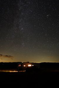 Illuminated building against sky at night