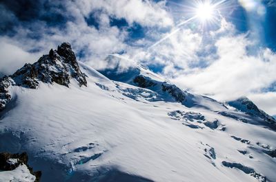 Low angle view of snowcapped mountains against sky