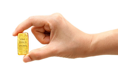 Close-up of hand holding hands over white background