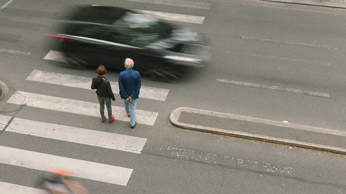 High angle view of people walking on road