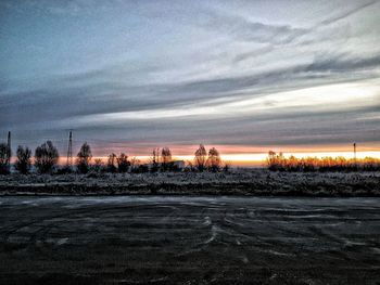 Scenic view of field against sky during sunset