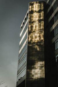 Low angle view of modern building against sky in city