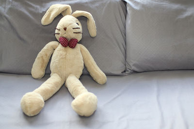 Bunny plush in sitting position on the bed