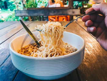 Midsection of person having food in bowl