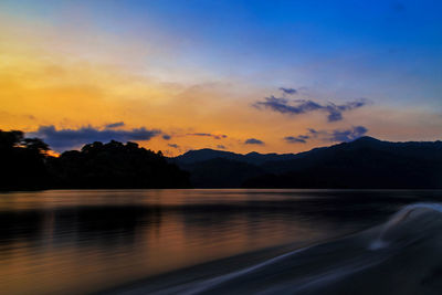 Scenic view of lake against sky during sunset