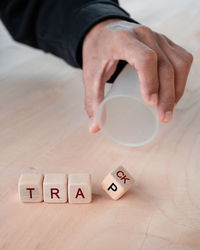 High angle view of hand with text on table