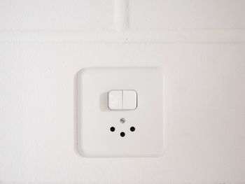 Close-up of electric lamp on wall