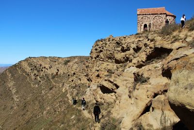 Low angle view of castle on mountain against sky