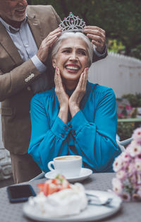 Portrait of smiling young woman holding food