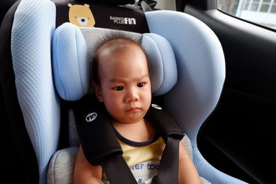 Portrait of cute baby girl in car