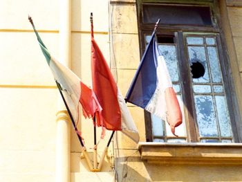 Low angle view of flags hanging on building