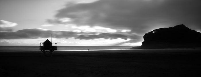 Silhouette people on beach against sky