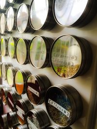 Close-up of spices and herbs with labels at rack