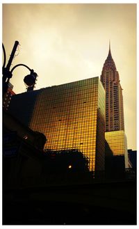 Low angle view of buildings against sky at sunset