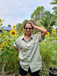 Low section of woman standing by tree