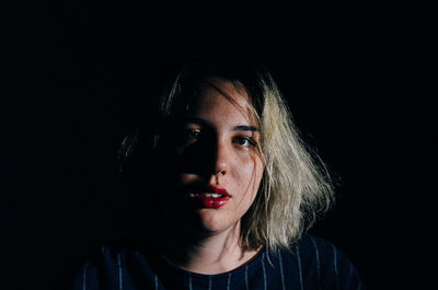 Portrait of woman in darkroom
