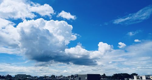 Low angle view of buildings against blue sky