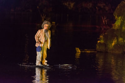 Girl standing by lake