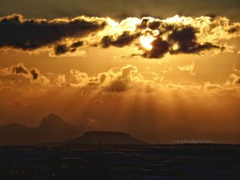 Scenic view of silhouette mountains against sky during sunset
