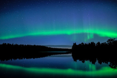 Scenic view of lake against sky at night