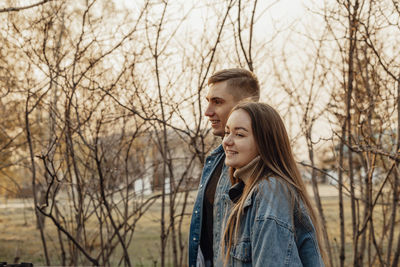 A couple in motion walks in the park in spring or autumn, happy lifestyle concept