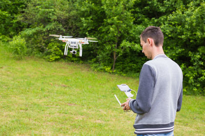 Man holding camera while standing by airplane