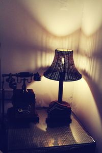Close-up of electric lamp on table at home