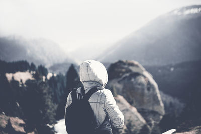 Rear view of hiker standing on mountain