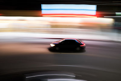 Blurred motion of car on road at night