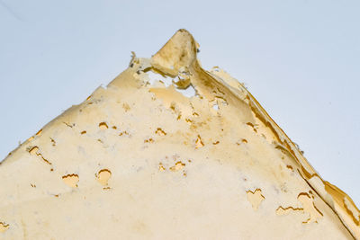 Low angle view of weathered wall against clear sky